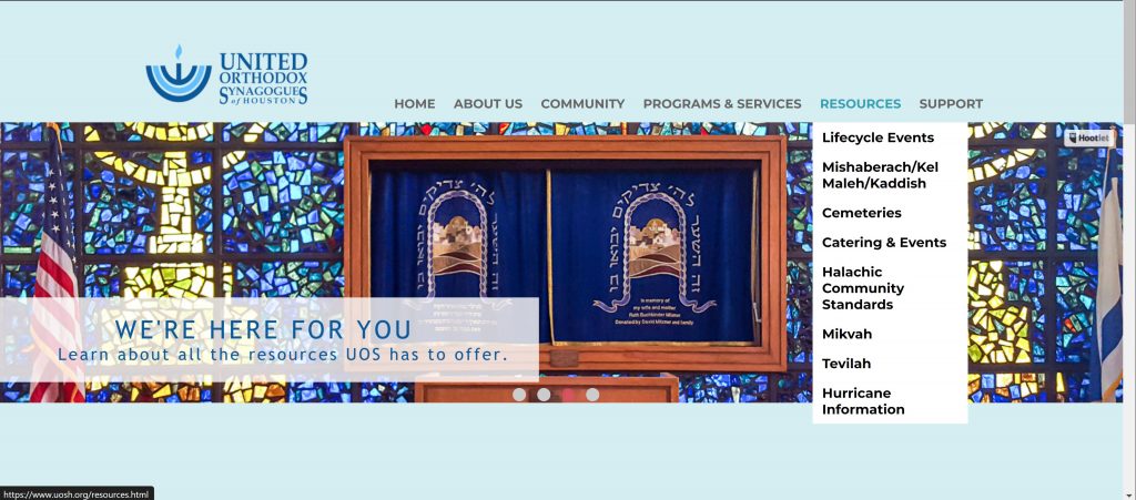 Screenshot of the United Orthodox Synagogues of Houston website home page featuring a beautiful blue and yellow stained glass window in front of the 